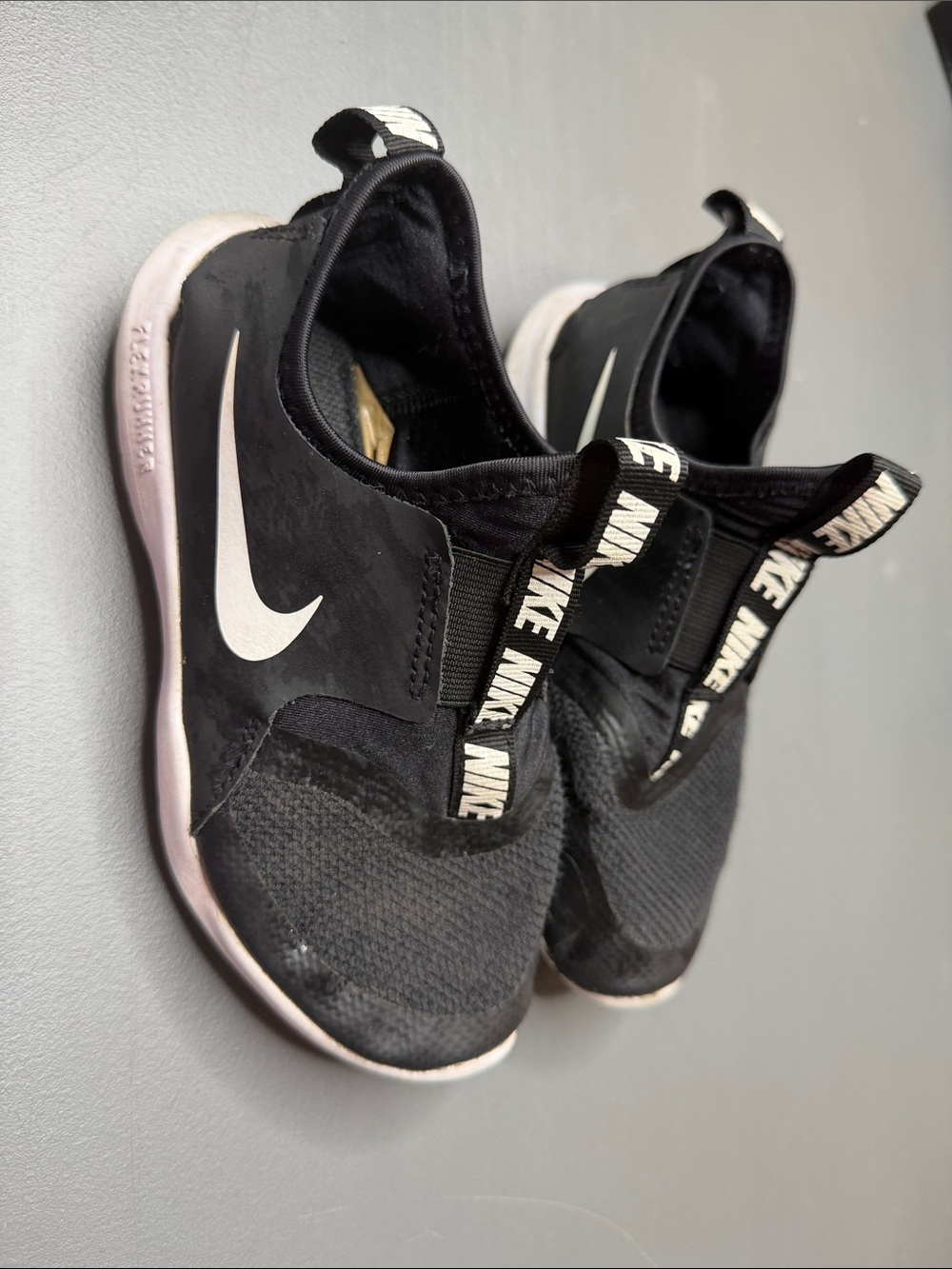Nike Black Slip-On Sneakers with White Swoosh and Pull Tabs. Kid’s size: 13